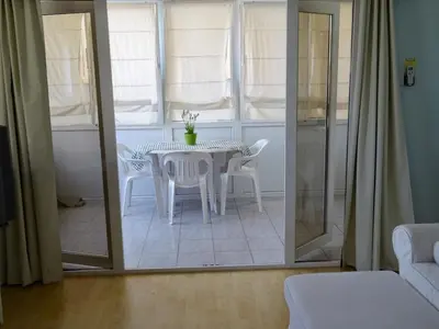 a dining room with a white table and chairs at Camilla City apartment in Larnaka