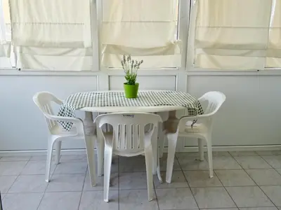 a white table and chairs with a potted plant on it at Camilla City apartment in Larnaka