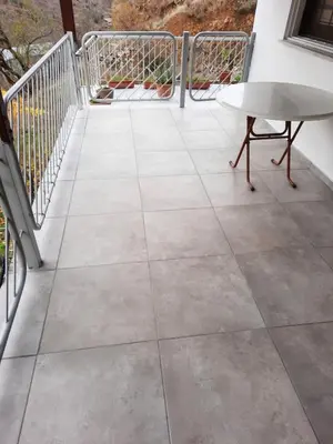 a patio with a table and a bench on a balcony at Kampi Double Storey House in the Village in Nicosia