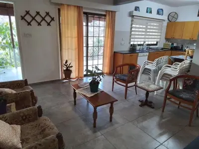 a living room with chairs and a table at Kampi Double Storey House in the Village in Nicosia