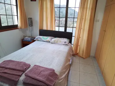a bedroom with a bed with two towels on it at Kampi Double Storey House in the Village in Nicosia