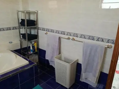 a bathroom with a sink and towels on a rack at House on the hill in Xylophaghou