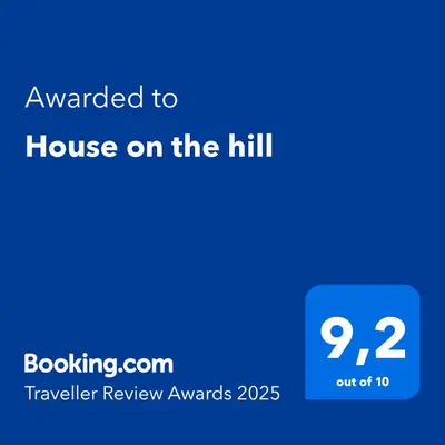 a screenshot of a phone with the text awarded to house on the hill at House on the hill in Xylophaghou