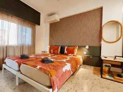 a bedroom with a large bed and a mirror at Elena Holiday Apartment in Larnaka