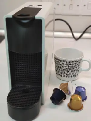 a black laptop computer sitting next to a coffee cup at Elena Holiday Apartment in Larnaka