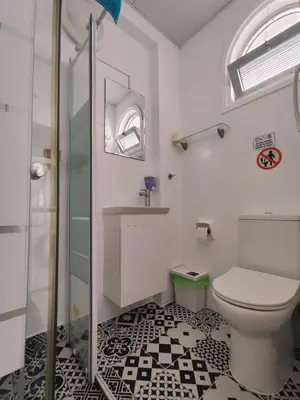 a bathroom with a toilet and a glass shower at Elena Holiday Apartment in Larnaka