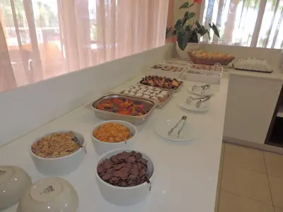 a counter with bowls of food on a counter top at La Casa Di Napa Apartments in Ayia Napa