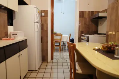a kitchen with a table and a white refrigerator at Maria Court 2, Apt 32 in Larnaka
