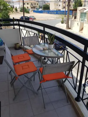 a table and chairs sitting on a balcony at Ria Court 33 in Larnaka