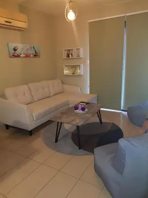 a living room with a couch and a coffee table at Ria Court 33 in Larnaka