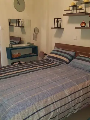 a bedroom with a bed and a dresser at Ria Court 33 in Larnaka