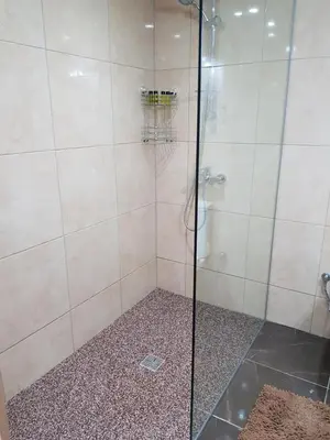a bathroom with a shower with a glass door at Haig's Dream Flat On The Beach in Larnaka