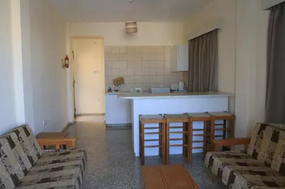 a kitchen with a table and chairs and a counter at Maricosta Apartments in Protaras