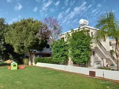 a building with a yard in front of it at Maricosta Apartments in Protaras