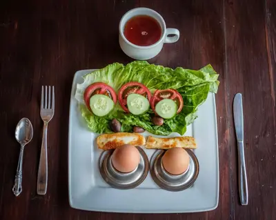 a plate of food with eggs and lettuce and tomatoes at Summer Dream Cyprus in Maroni