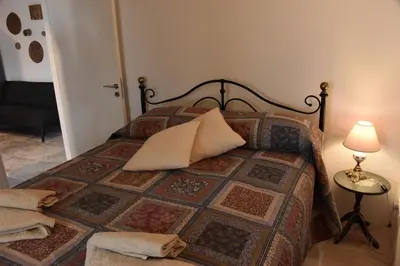 a bedroom with a bed with a pillow on it at Athieno - Αθηαινώ in Athienou