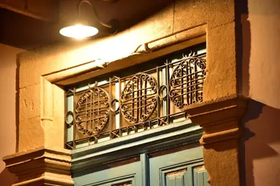 a building with a wrought iron fence over a door at Athieno - Αθηαινώ in Athienou