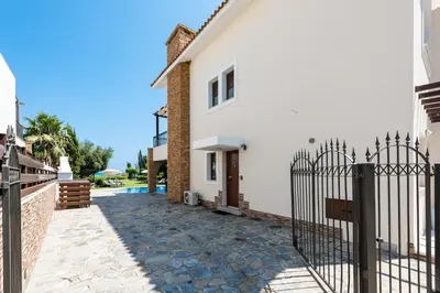 a villa with a gate in front of a house at Sea Front Oceanus H3 by Ezoria Villas in Ayia Napa