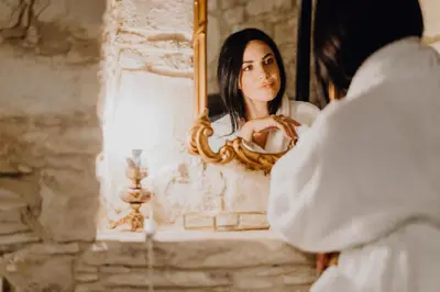 a woman looking at her reflection in a mirror at Oinou Strata - Adults Only in Vouni