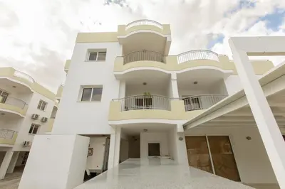 a large white building with a balcony at Oceania Bay Village in Pyla