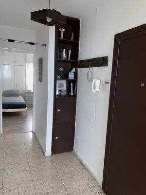 a hallway with a room with a bed and a phone at Glabur Stays - The Cozy 2 BDR - Nicosia City, Free Parking & Wifi, Welcomes You!!! in Nicosia