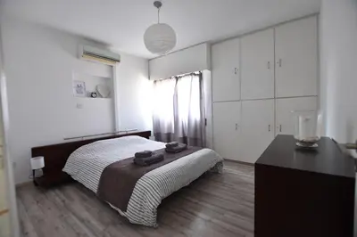 a bedroom with a bed and a dresser in it at Glabur Stays - The Cozy 2 BDR - Nicosia City, Free Parking & Wifi, Welcomes You!!! in Nicosia