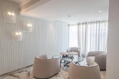a room with chairs and a table and a window at Kokkinos Boutique Hotel in Protaras