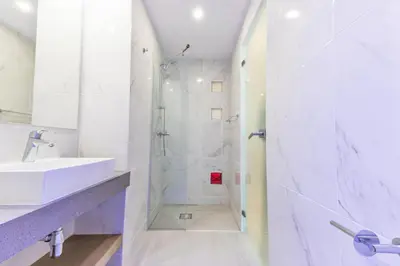 a white bathroom with a sink and a shower at Kokkinos Boutique Hotel in Protaras