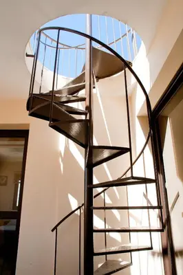 a spiral staircase in a house with a window at Blue Serenity Complex in Larnaka