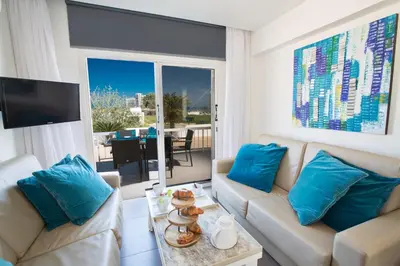 a living room with two couches and a tv at Nicholas Seaview Apartments in Protaras