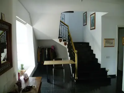 a room with a staircase with a table and a stair case at Private deluxe room with balcony at Datacom building in Nicosia