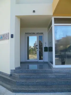 an entrance to a building with a glass door at Private deluxe room with balcony at Datacom building in Nicosia