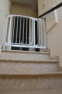 a white metal railing on the side of a staircase at Maricosta Villas in Protaras