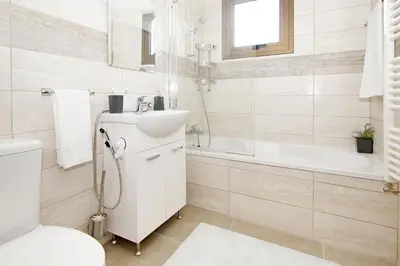 a bathroom with a sink and a toilet and a tub at Villa Marion in Ayia Napa