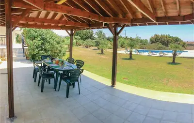 a table and chairs under a pavilion on a patio at Stunning Home In Maroni-Larnaca in Pervolia