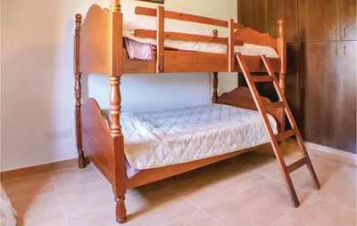 two bunk beds in a room with a ladder at Stunning Home In Maroni-Larnaca in Pervolia