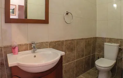 a bathroom with a sink and a toilet at Stunning Home In Maroni-Larnaca in Pervolia