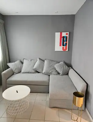 a living room with a couch and a table at Beachfront Amazing New Apartment in Limassol