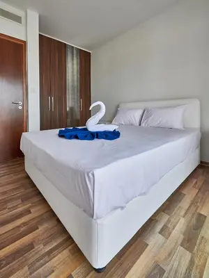 a large white bed with a blue ribbon on it at Angie Luxury Beach Villas in Ayia Napa
