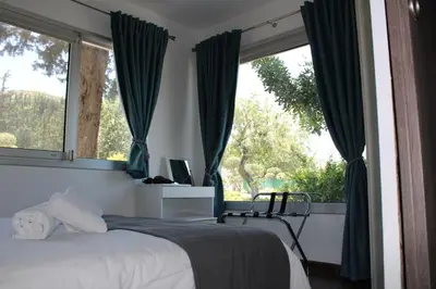 a bedroom with a bed and a large window at St.George's Country Retreat in Limassol