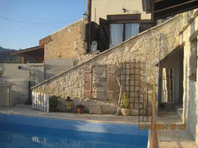 a house with a ladder next to a swimming pool at Oinochori in Vouni