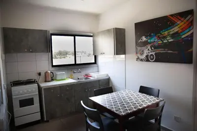 a kitchen with a table and a sink and a window at Olive Island in Larnaka