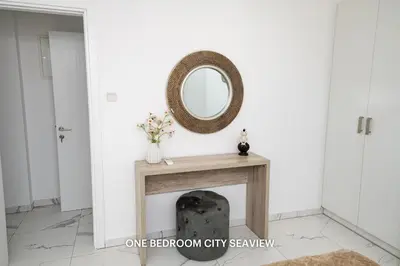 a mirror on top of a table in a room at Lazuli Seaview Apartments 2Bdr in Larnaka