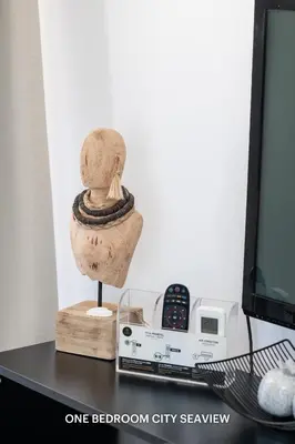 a statue of a head on a desk next to a computer monitor at Lazuli Seaview Apartments 2Bdr in Larnaka