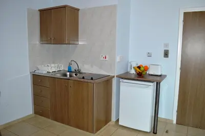 a small kitchen with a sink and a dishwasher at Millie's Apartments in Ayia Napa