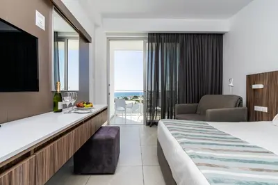 a hotel room with a bed and a view of the ocean at Eleana Hotel in Ayia Napa