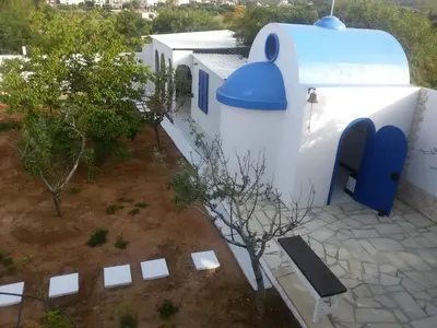 an overhead view of a building with a bench and trees at Flokkas Hotel Apartments in Protaras