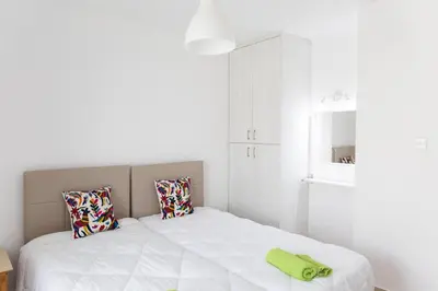 a bedroom with a bed with a green towel on it at Christothea Apartments in Ayia Napa