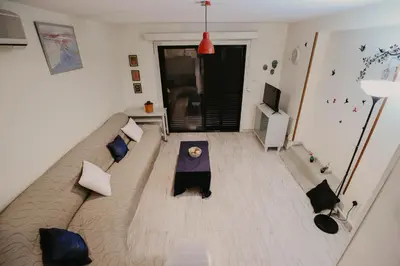 a living room with a couch and a table at Pirgos beach house in Larnaka