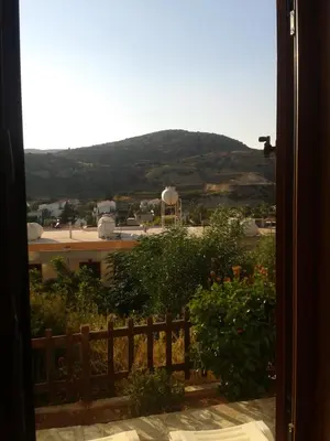 a view of a mountain from a window at Pelekanos Apartments in Pissouri